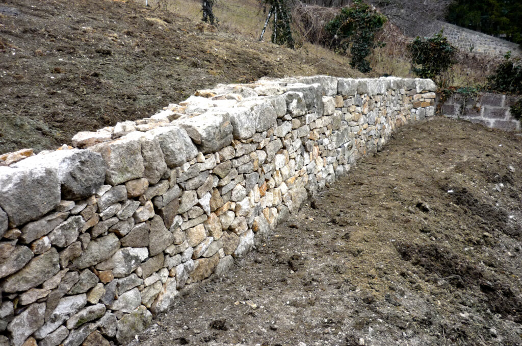 Mur de soutènement en pierre sèche aménageant une pente au Puy-en-Velay